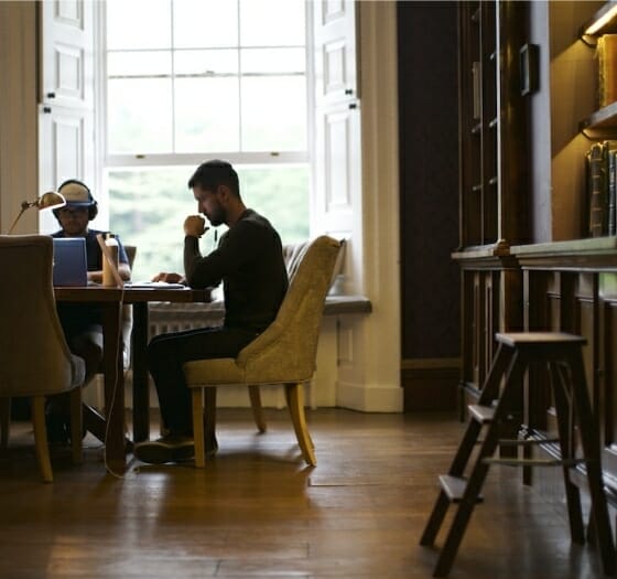 Man Studying At Desk In A Library Man Studying At Desk In A Library